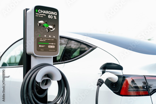 Electric car recharging battery at outdoor EV charging station for road trip or car traveling, alternative and sustainable energy technology for eco-friendly car. Perpetual