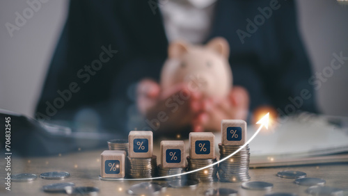 Businessman holding piggy bank and calculating income and return on investment in percentage. income, return, retirement, compensation fund, investment, Interest rate and dividend concept,