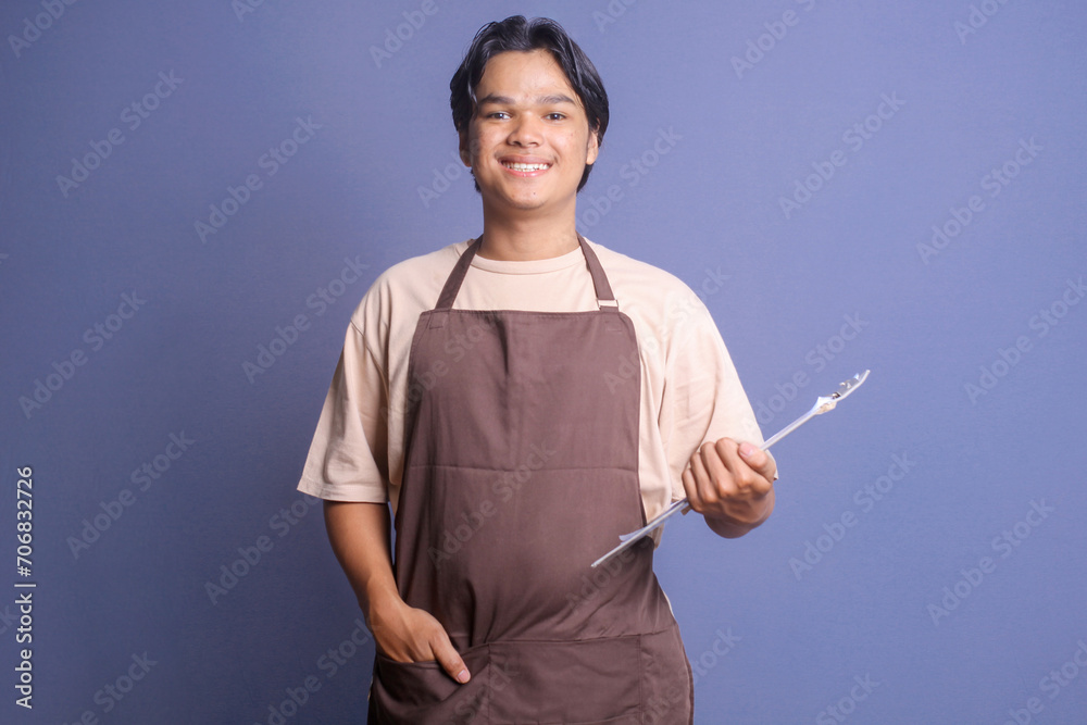 Portrait of young Asian barista holding clipboard and looking at camera smiling Portrait of young Asian barista holding clipboard and looking at camera smiling