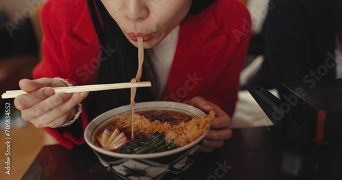 Woman  mouth and eating ramen in restaurant for dinner  meal and noodles in cafeteria. Closeup  hungry lady and chopsticks for bowl of spaghetti  Japanese cuisine and lunch break in fast food diner