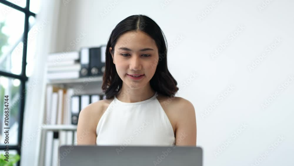Cheerful smiling businesswoman working with a laptop talks online Use a calculator to calculate annual financial statements. Turnover and profit balance sheet Financial records in the office. Cheerful smiling businesswoman working with a laptop talks online Use a calculator to calculate annual financial statements. Turnover and profit balance sheet Financial records in the office.