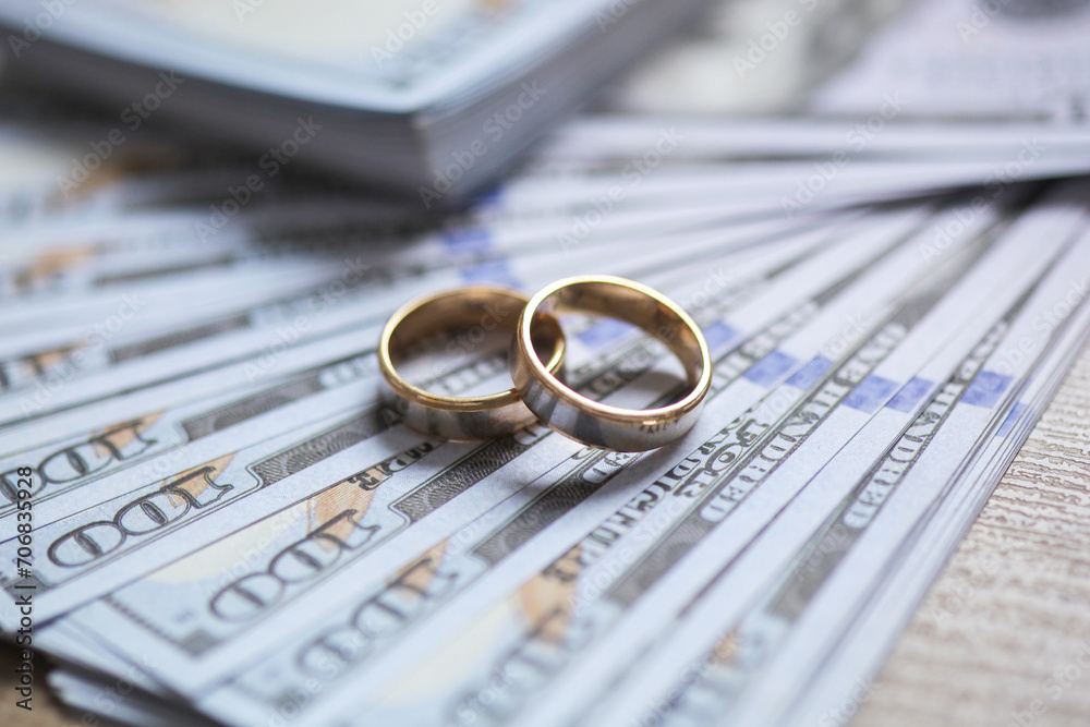 Golden wedding rings on money background Golden wedding rings on money background