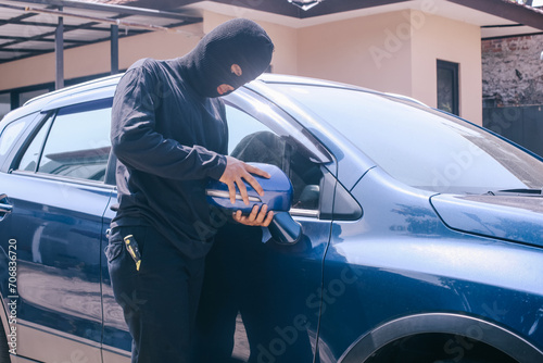 Photography A thief wearing black balaclava for disguise, entering private property to steal