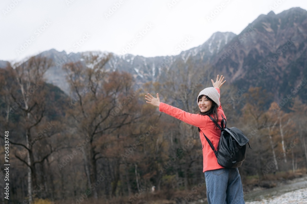 Nature's elegance, Asian woman in a pink fleece enjoys a snowy adventure. Elegant portrait by the lake capturing the achievement, excitement, and scenic beauty of Japan.