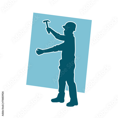 Silhouette of a worker carrying hammer tool. Silhouette of a worker in action pose using hammer tool.