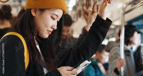 Japanese woman, online and train on smartphone, social media and public transportation on metro bullet. Person, cellphone and travel on fast vehicle for weekend trip and commute in tokyo on adventure