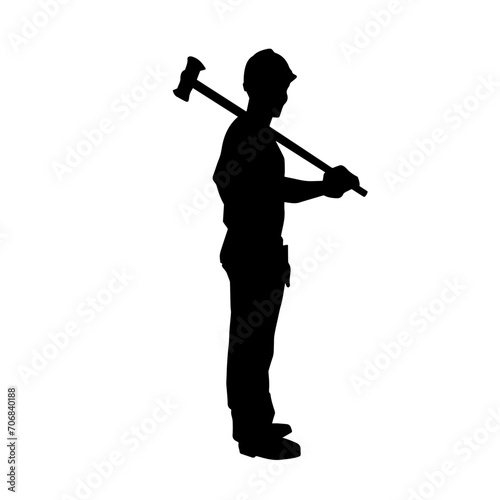 Silhouette of a worker in action pose using his sledge hammer tool.