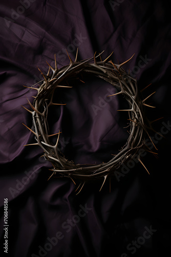 A crown of thorns on a white cloth on black background