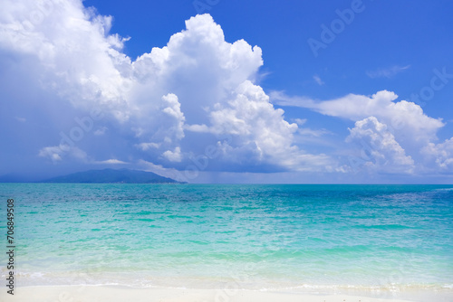 Fototapeta Naklejka Na Ścianę i Meble -  Beach sand for summer vacation concept. Beach nature and summer seawater with sunlight light sandy beach Sparkling sea water contrast with the blue sky.Beach sand for summer vacation concept.