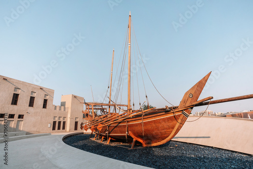 Old wooden rowing boat at historical are of Dubai. Boat installation. photo