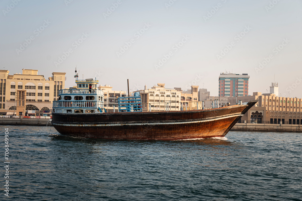 Arabian wooden traditional boat on water in the river in the old Dubai area.