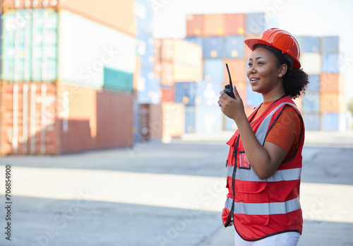 African factory worker or engineer holding wireless radio in containers warehouse storage