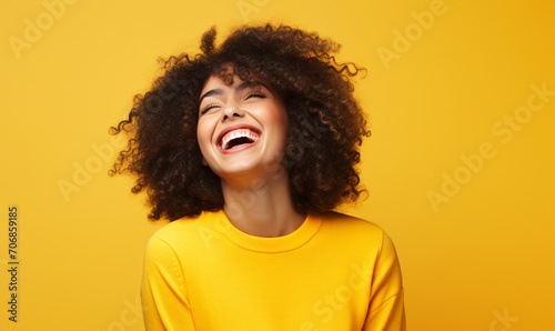 Happy girl with perfect laughing and smiling isolated on yellow background.