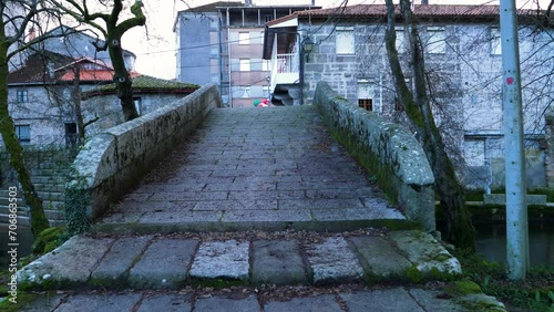 Weathered stone steps of granite up to river Molgas Roman bridge photo