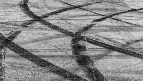 Tire track mark on asphalt tarmac road race track texture and background, Abstract background black tire tracks skid on asphalt road in racing circuit, Tire mark skid mark on asphalt road. photo