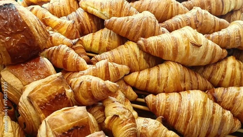 Delicious baked croissants. Fresh pastries on display in the morning. Fragrant soft bread and French croissants for breakfast photo