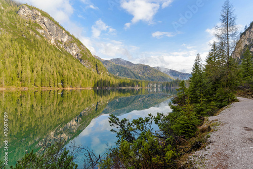 Fototapeta Naklejka Na Ścianę i Meble -  beautiful landscape of mountain lake Braies in the Dolomites, Italy. Hiking trail along the lake and low clouds over the mountain