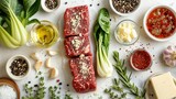 some raw ingredients to make a recipe, such as steak, garlic, bok choy, cheese, butter on a white countertop  