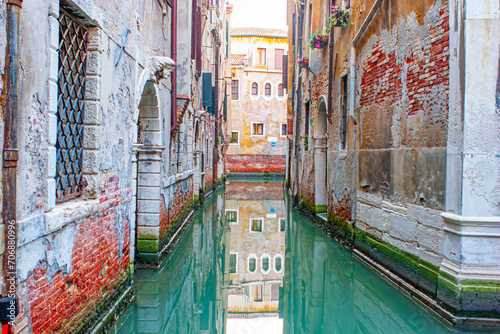 reflectio of old facades in a narrow canal in Venice photo
