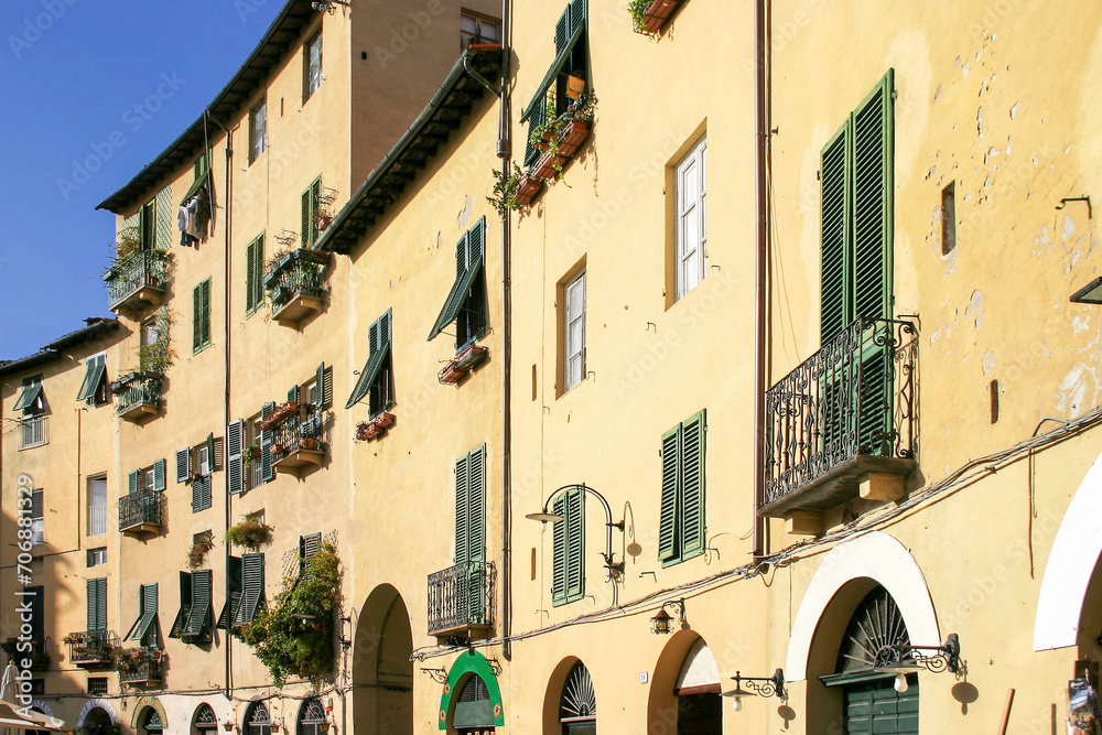 facade of the houses at the historic market square Piazza del Anfiteatro in Lucca, Tuscany
