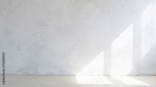 Minimalistic abstract light grey wall background for product presentation with sunlight shadow