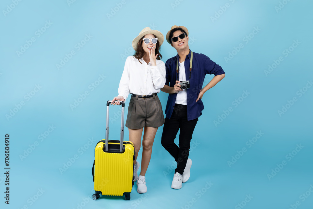 Young Asian couple tourists are excited to go to travel on blue background Young Asian couple tourists are excited to go to travel on blue background