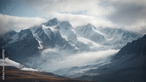 A dramatic snowy mountain range, with jagged peaks and deep valleys, shrouded in mist and mystery. © DynaVerse3D