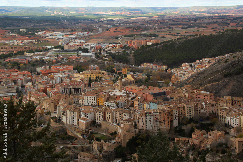 Aerial view of the historic center of the city of Cuenca with colorful houses, Torre de Mangana tower and surrounding walls with the valley in the background near Madrid, Spain