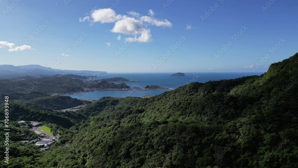 Cloudy sky over tropical mountains. Travel in Taiwan. Cinematic panoramic view over mountains in Taiwan with sea in background.Slow drone movement over the small town of Jiufen in Taiwan. Cloudy sky over tropical mountains. Travel in Taiwan. Cinematic panoramic view over mountains in Taiwan with sea in background.Slow drone movement over the small town of Jiufen in Taiwan.