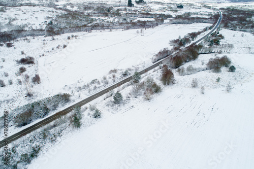 aerial view with drone of a road in a snowy landscape © Vic