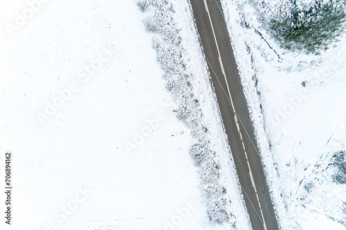 aerial top drone view of a road in a snowy landscape
