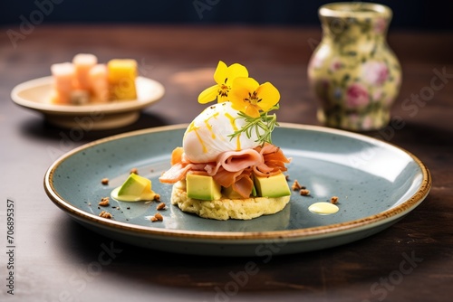 eggs benedict with a slice of avocado on top, served with hash browns