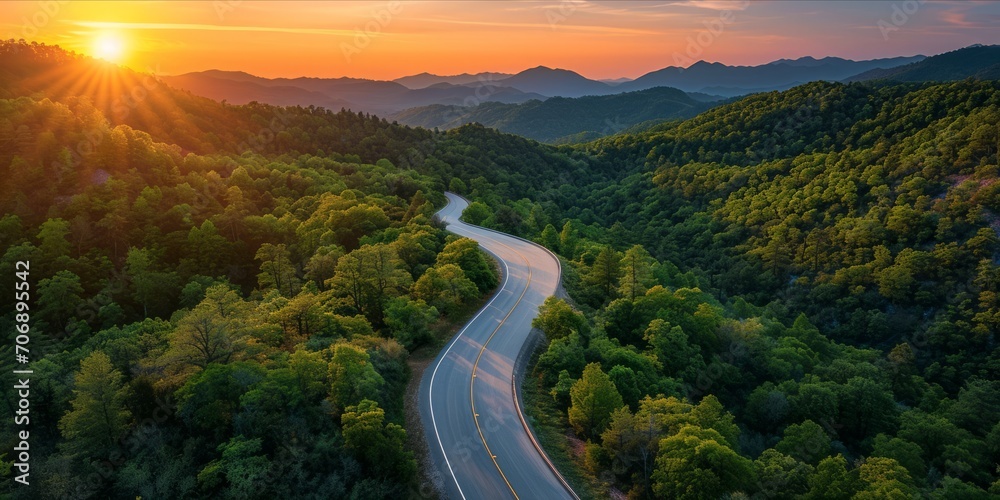 Winding Road Through a Sunset Kissed Forested Mountain