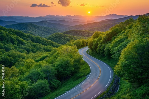 Winding Road Through a Sunset Kissed Forested Mountain