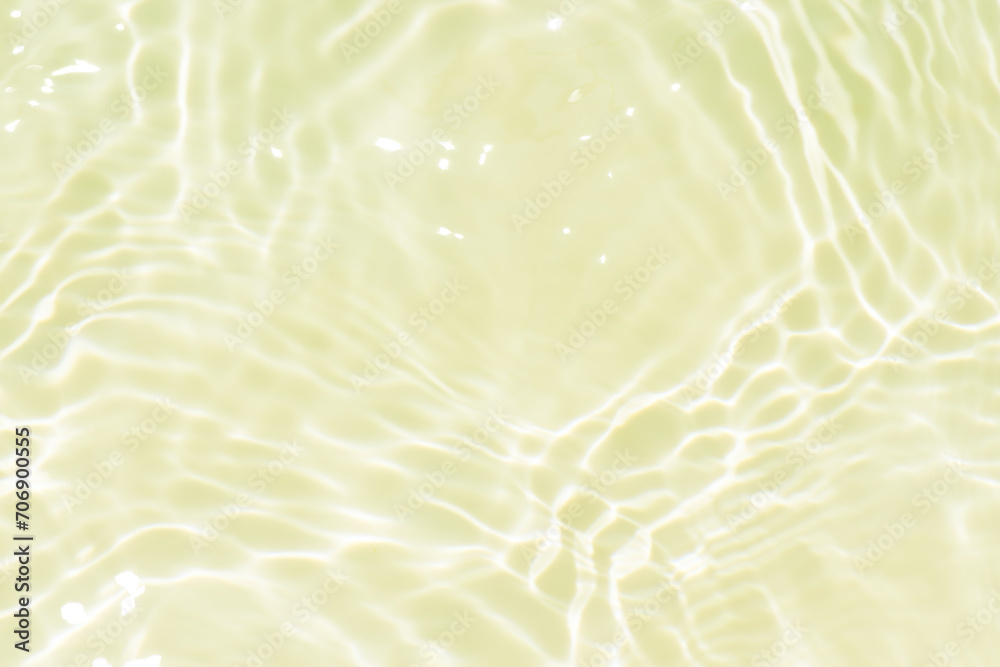 Fototapeta premium Bluewater waves on the surface ripples blurred. Defocus blurred transparent blue colored clear calm water surface texture with splash and bubbles. Water waves with shining pattern texture background.