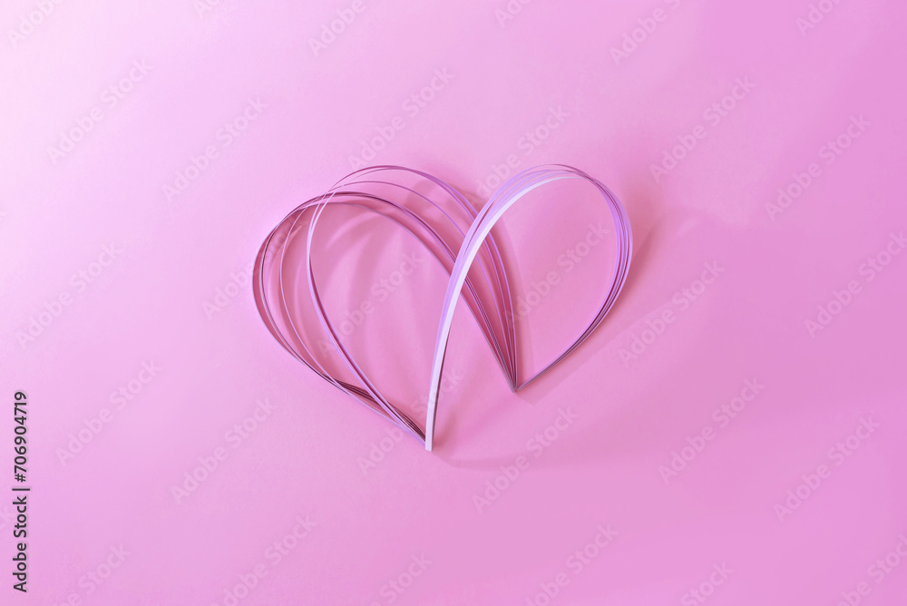Aesthetic creative pastel pink paper heart with soft light and shadows on pink background, beautiful Valentine day postcard template, love concept