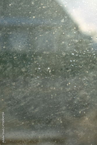 Window glass with water drops, view from inside