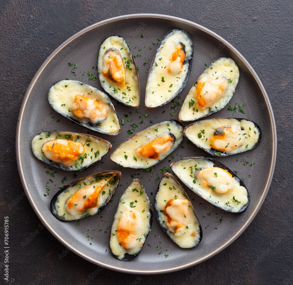 Baked mussels with cheese and herbs. Seafood. Healthy eating.
