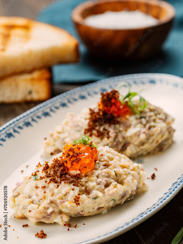 Fish appetizer forshmak - minced meat from herring fish, decorated caviar on plate. Traditional Jewish cuisine dish vorschmack forshmak made of herring fillet as independent dish on wooden background Fish appetizer forshmak - minced meat from herring fish, decorated caviar on plate. Traditional Jewish cuisine dish vorschmack forshmak made of herring fillet as independent dish on wooden background