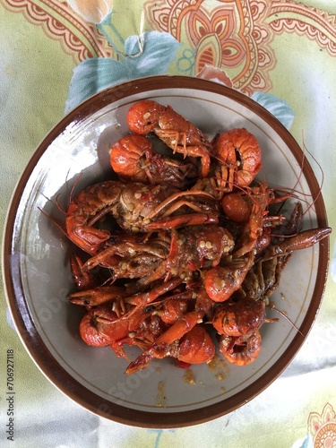 Savor the flavor of delicious freshwater lobster in vibrant orange hues. Perfectly cooked and ready to indulge. Culinary delight for food lovers photo