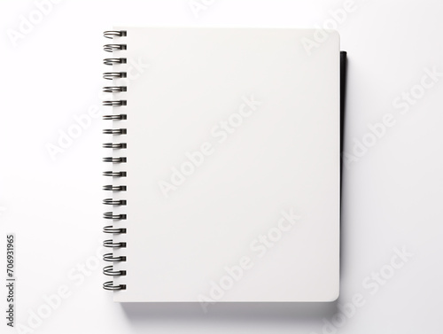 a spiral bound notebook with a white cover