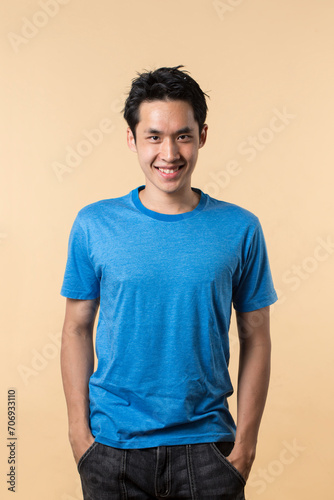 Wallpaper Mural Portrait of Chinese man standing against cream background. Torontodigital.ca