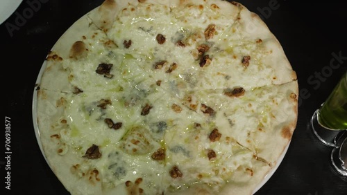 Creamy pizza with walnuts and various types of cheese