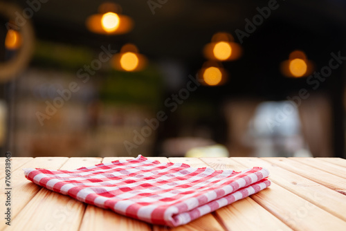 Empty wooden deck table with tablecloth over bokeh background. High quality photo