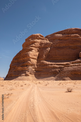 A stunning rock formation stands prominently in the vast and barren Wadi Rum desert in Jordan.