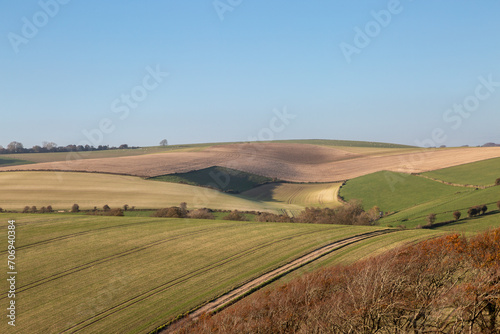 Looking out over an undulating Sussex landscape with a blue sky overhead