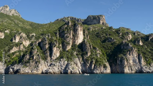 Majestic mountain cliffs and scenery of Italian Amalfi Coast from the sea on beautiful blue sky day. photo