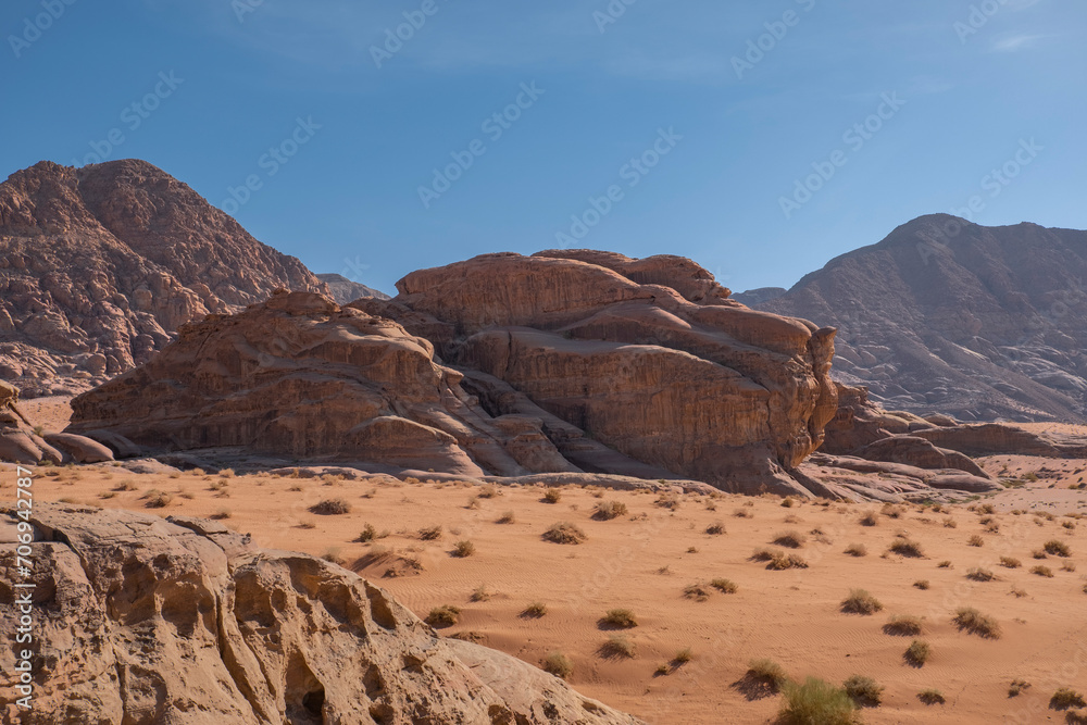 Majestic Rock Formations Under Clear Skies in Wadi Rum Desert, Jordan