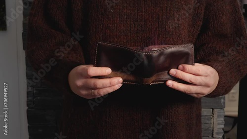 Woman holding empty wallet, flames coming from billfold. Financial concept, 60fps