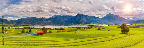 panoramic landscape and nature with lake Forggensee and alps mountain range in Bavaria, Germany photo